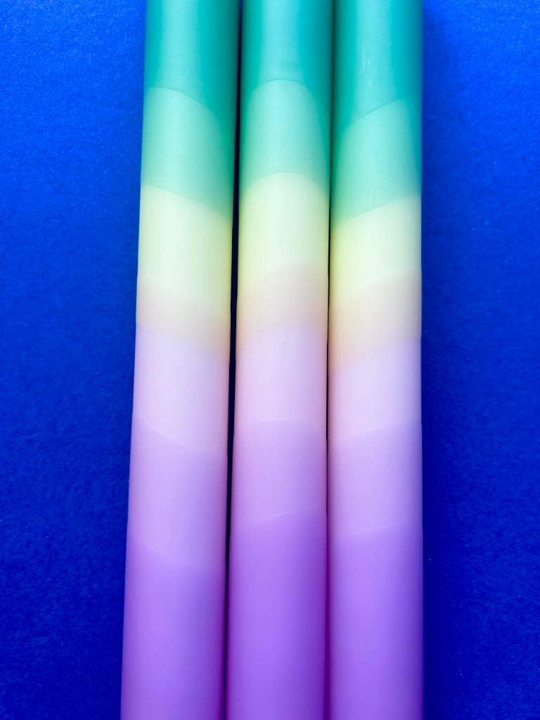 Set of 3 table candles. Colours pastel lilac moving through yellow topped with teal.