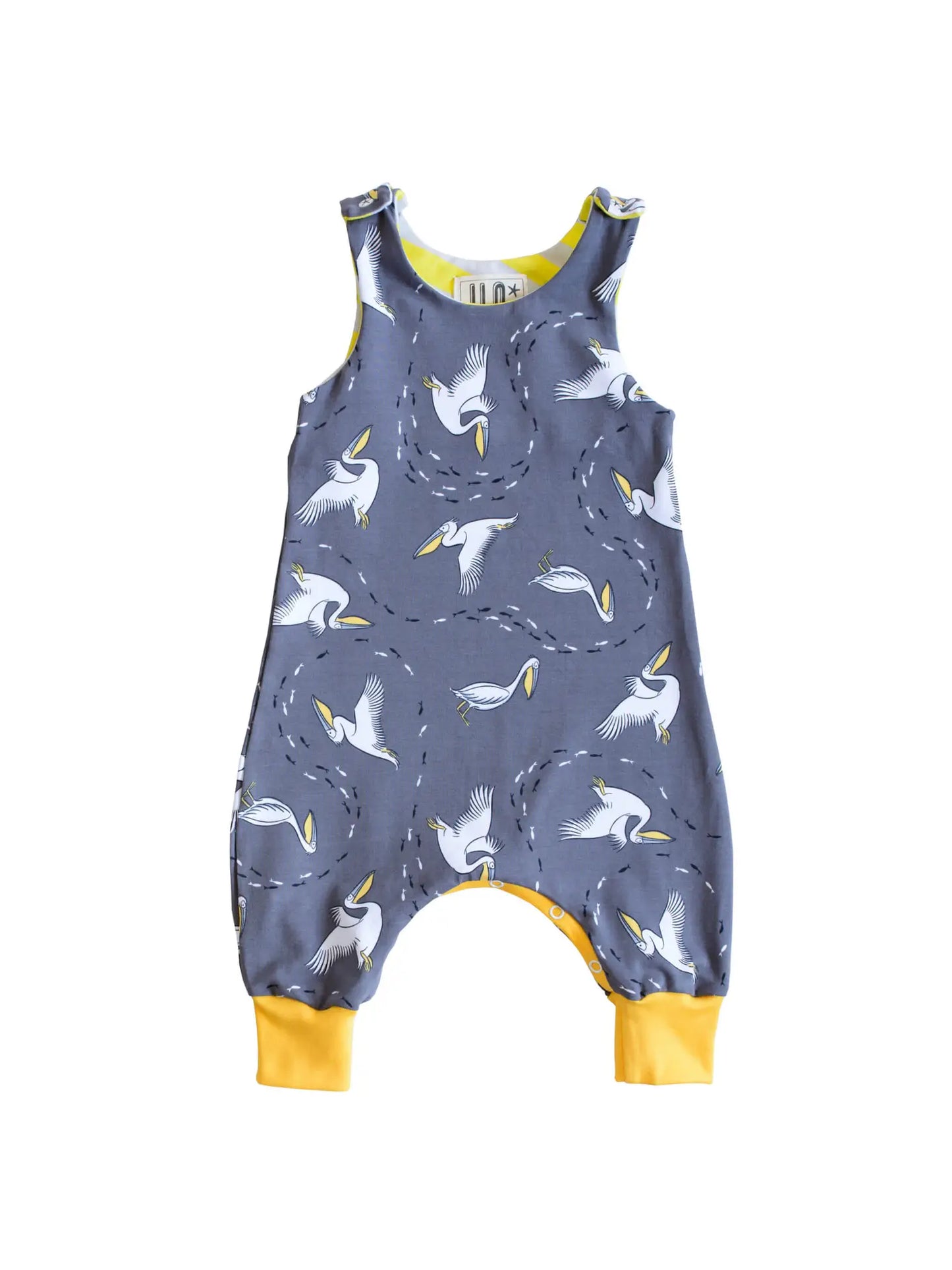 Sleeveless Romper with adjustable poppers as baby grows. Fabric design with pelicans on a grey background. Designed in Bristol.