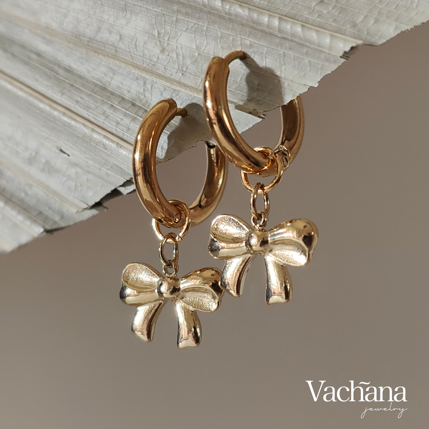 Gold plated hoop with bow charm