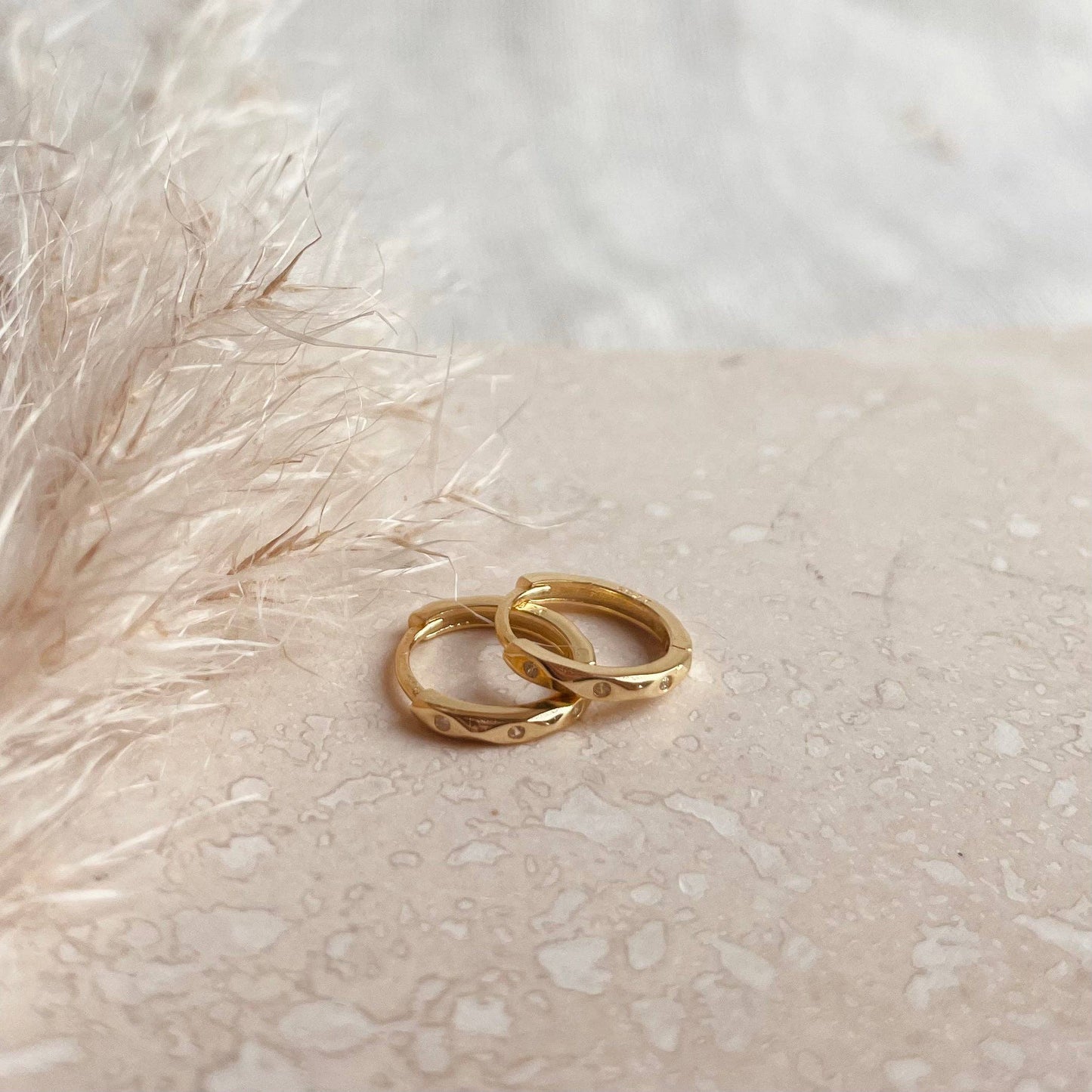 Gold plated huggy earrings with 3 tiny sparkle stones.
