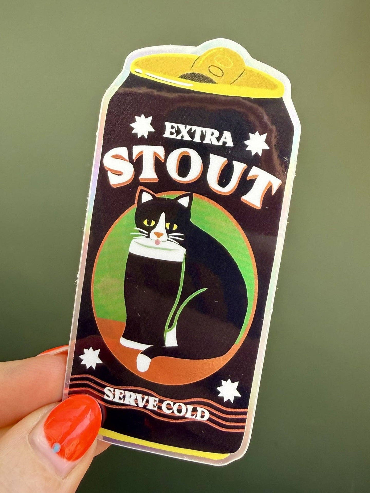Sticker design resembling a beer bottle labeled 'Extra Stout' with a cat illustration on a green background.