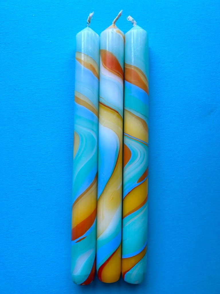 marbled dinner candles, blues and yellows.