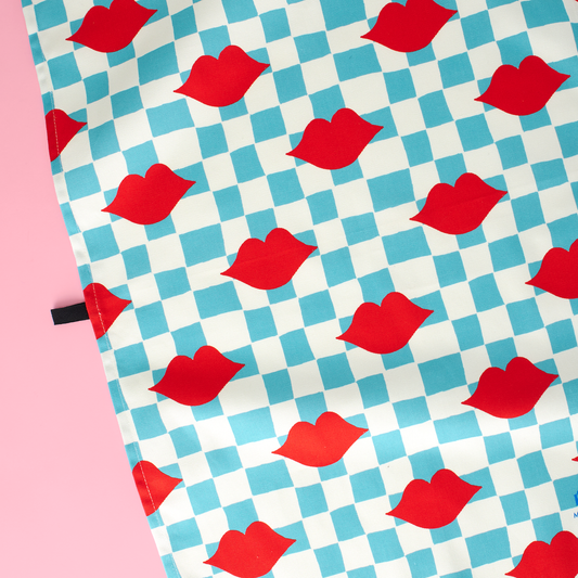 Patterned fabric with red lips on a blue and white checkered background