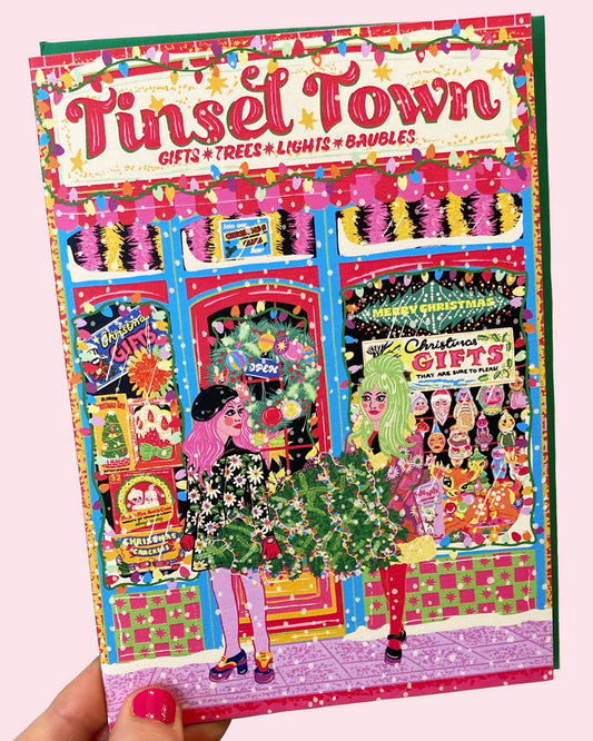 Colorful book cover of 'Tinsel Town' with festive illustrations and text.