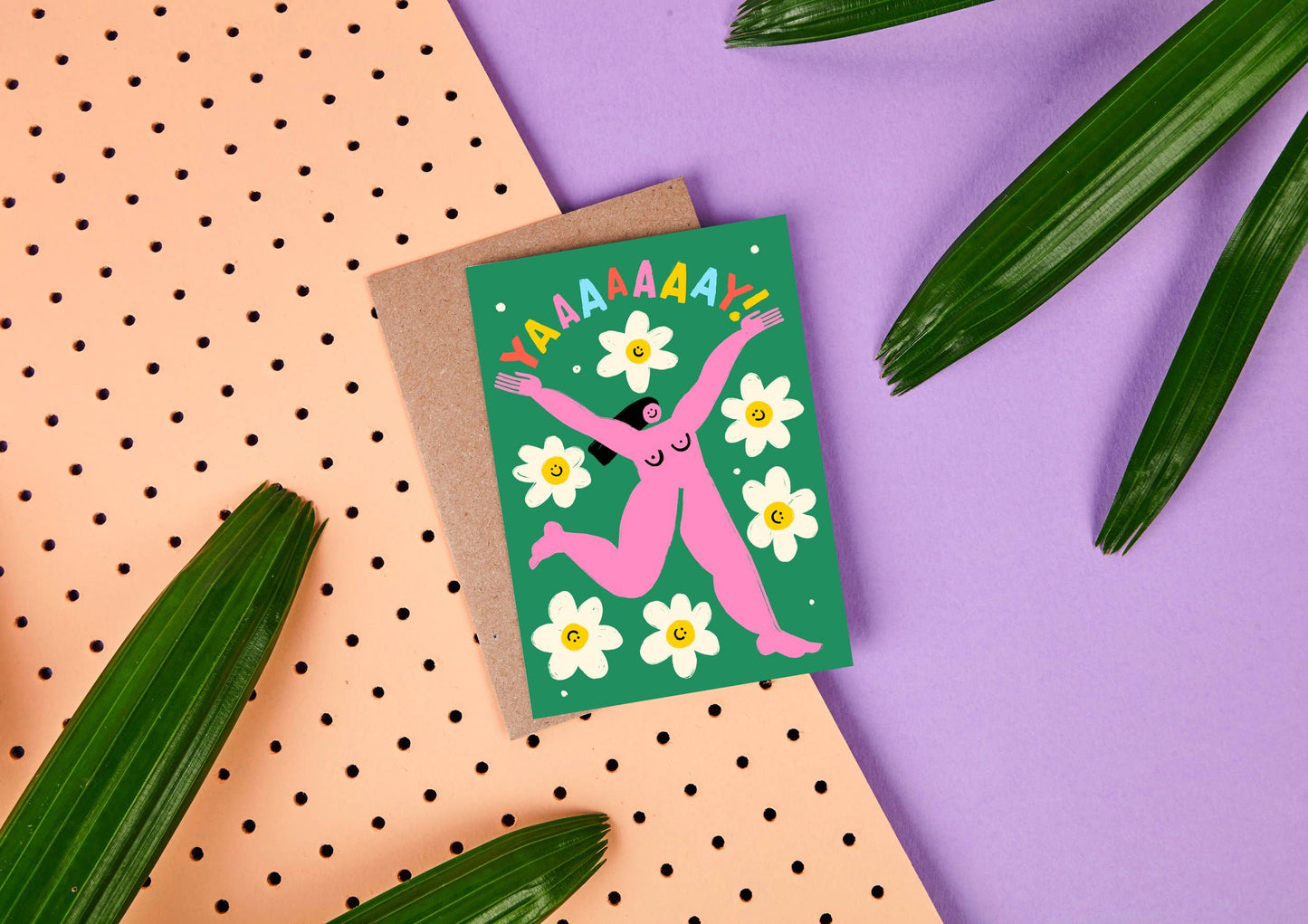 Celebration Card. The text in bright colours reads Yaaay! With a pink naked lady joyfully running amongst daisies on a green background.