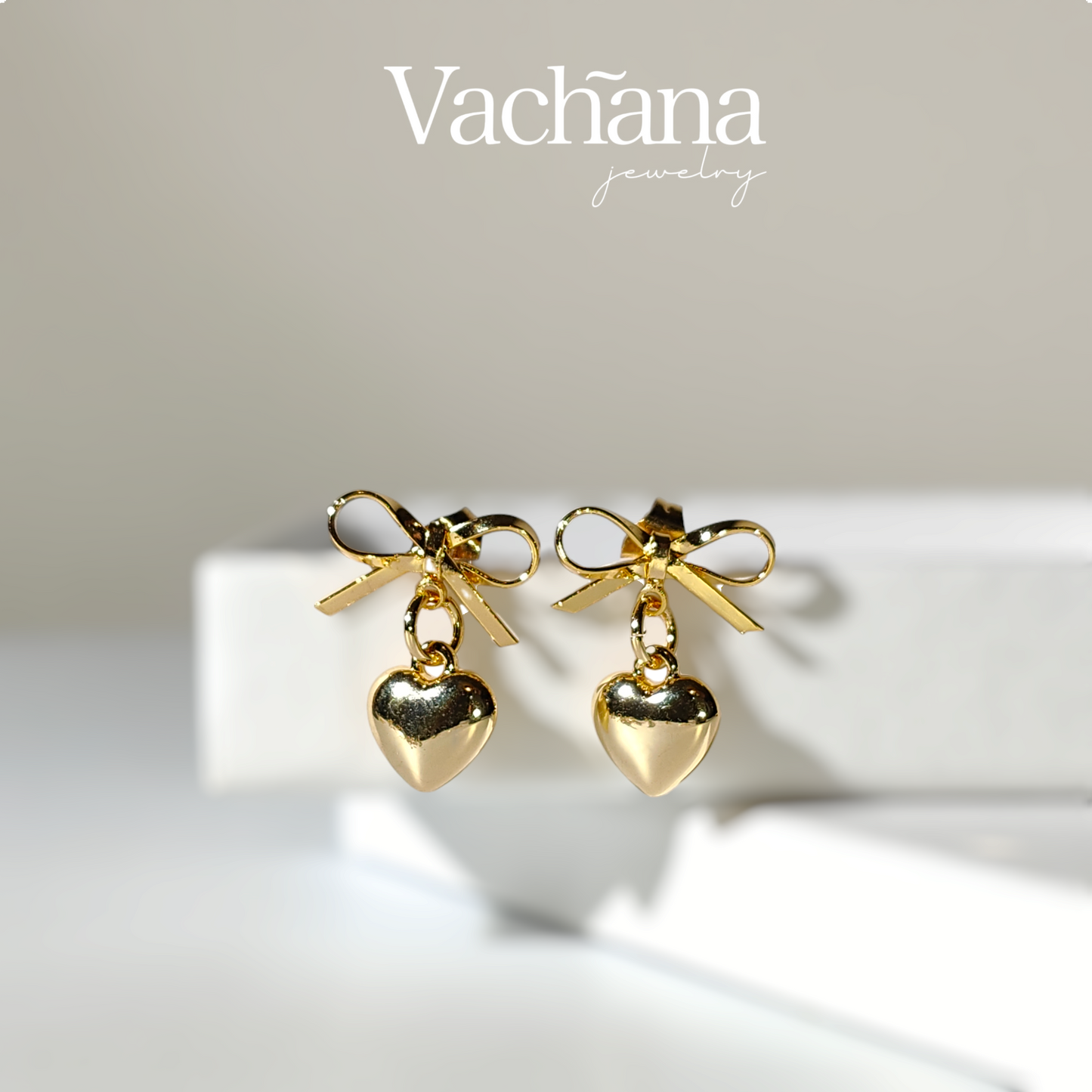 Gold plate bow with dangling heart