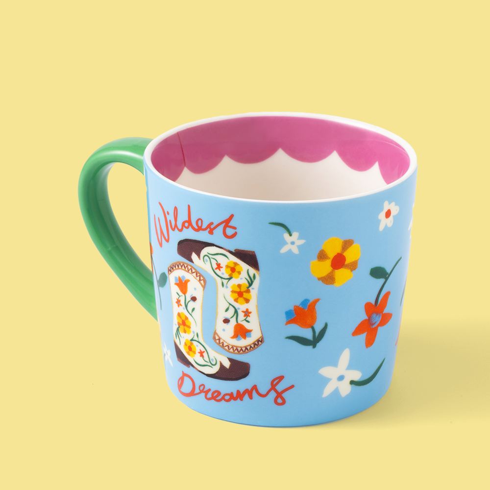 Colorful mug with cowboy boot and floral design on a yellow background
