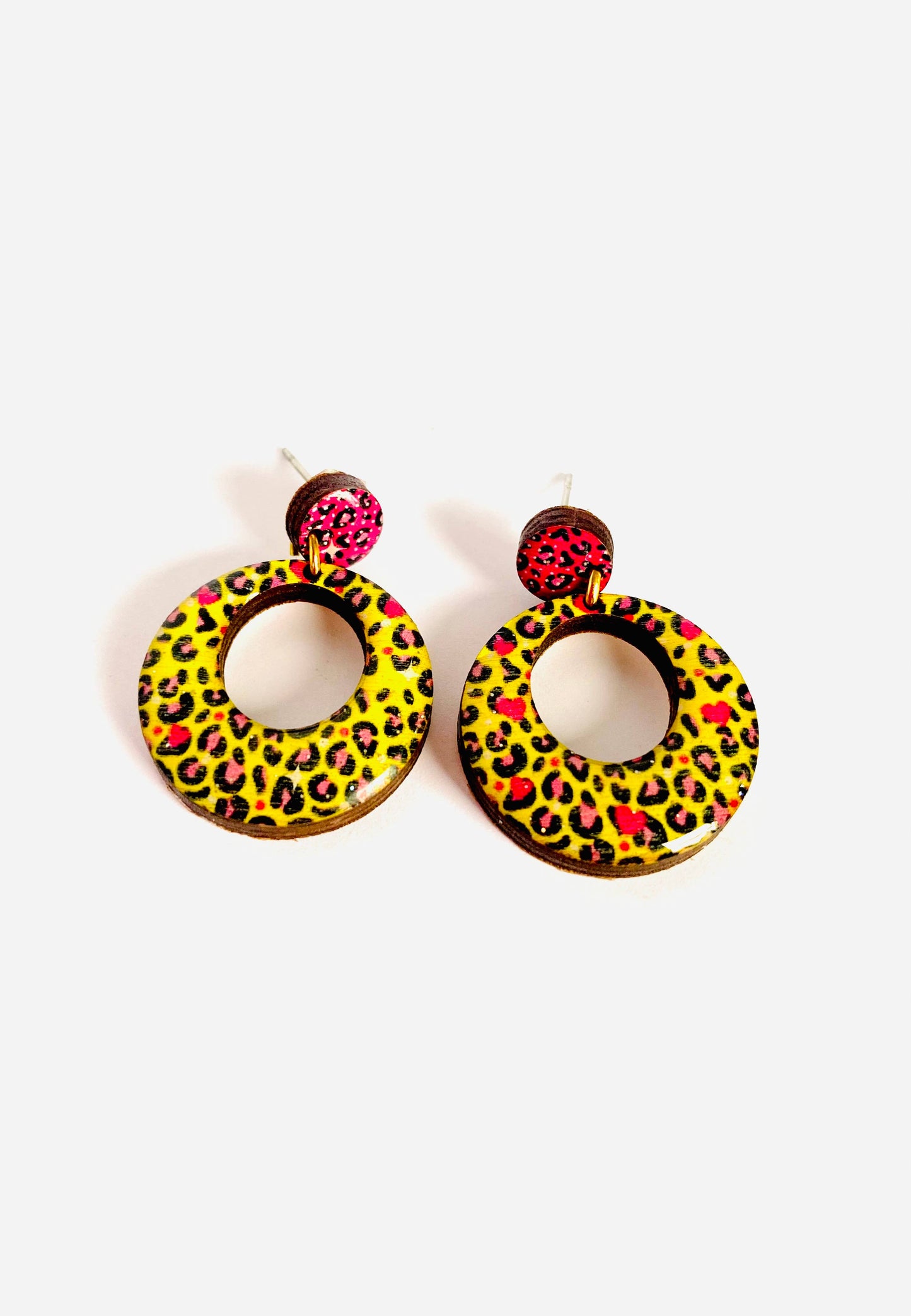 Pink and yellow leopard print earrings made from resin and wood.