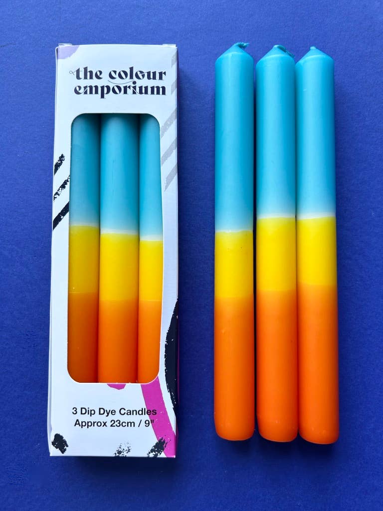 Trio of dip dyed candles. A band of orange, yellow and topped with turquoise.