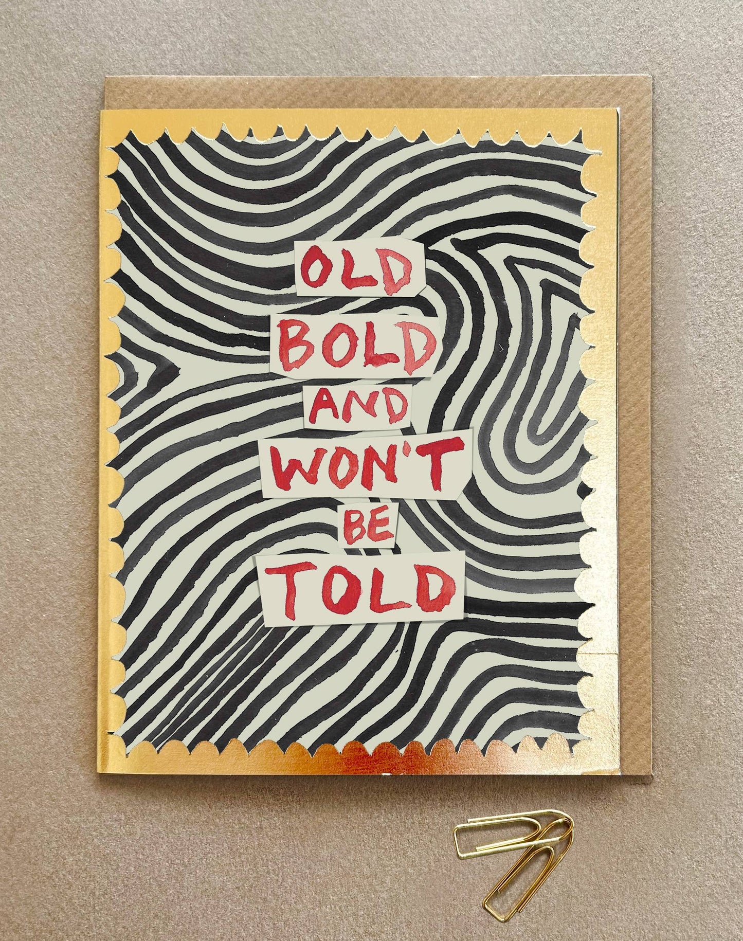 Greeting card with wavy pattern and text 'Old Bold and Won't Be Told' on a beige background