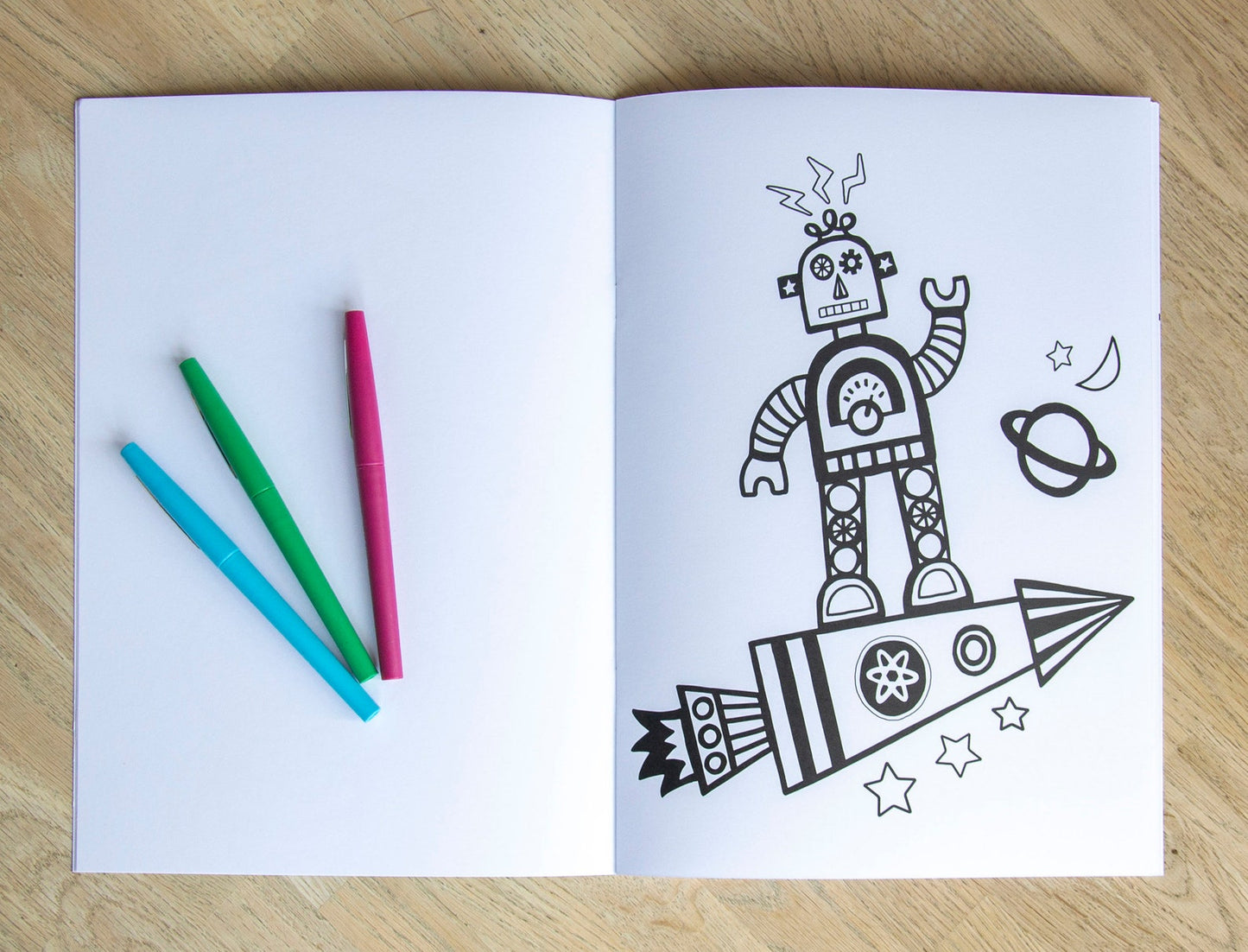A colouring page book of a robot on a rocket.
