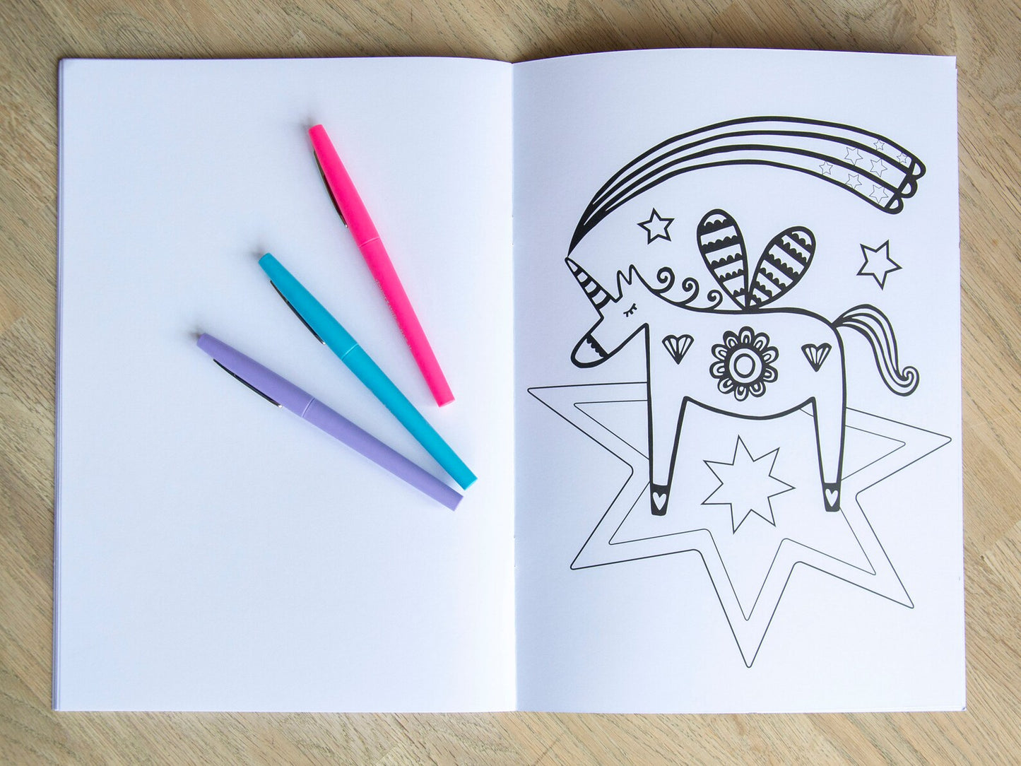 A colouring book page of a unicorn on a star.