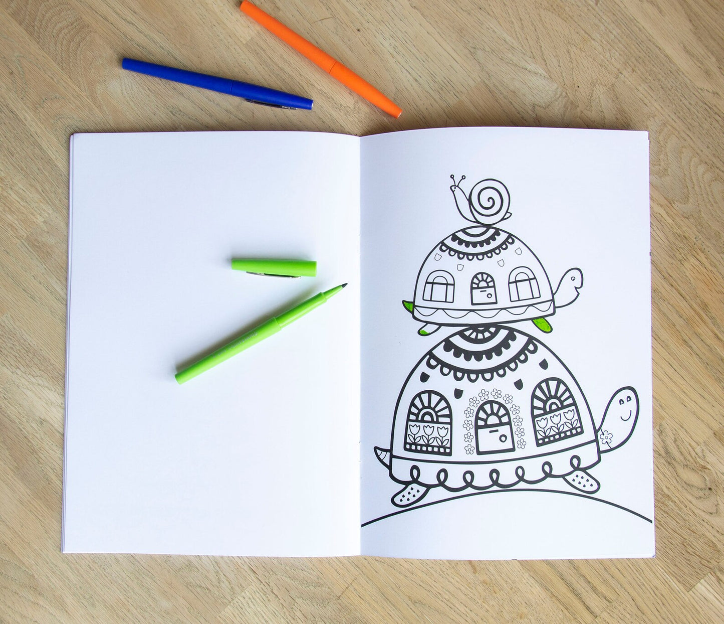 A colouring page book of a snail on top of a tortoise on top of a tortoise.