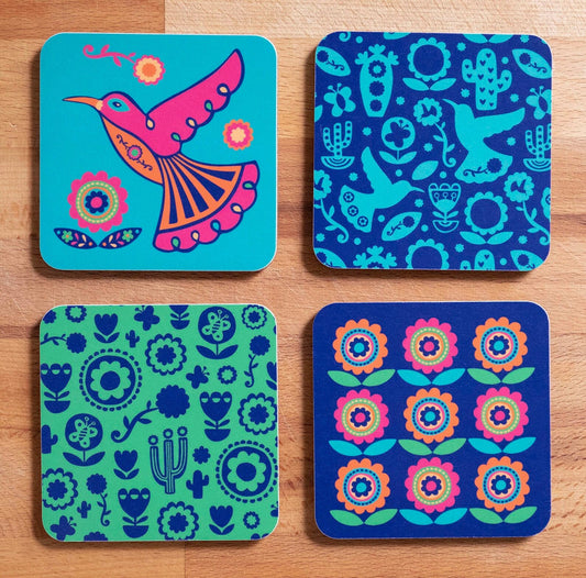 A set of four vibrant coasters featuring a hummingbird, hummingbird pattern, cactus pattern and flower pattern.