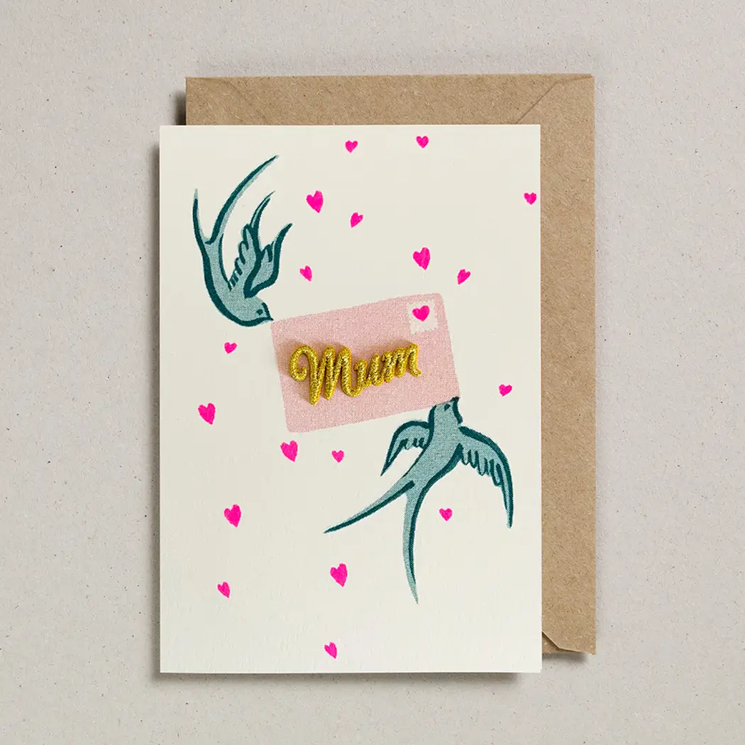 Mum Card with two swallows holding a letter with a gold embodied mum in the centre. Card