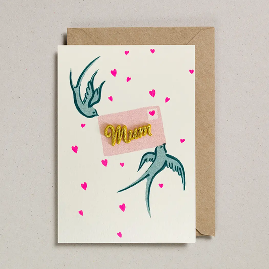 Mum Card with two swallows holding a letter with a gold embodied mum in the centre. Card