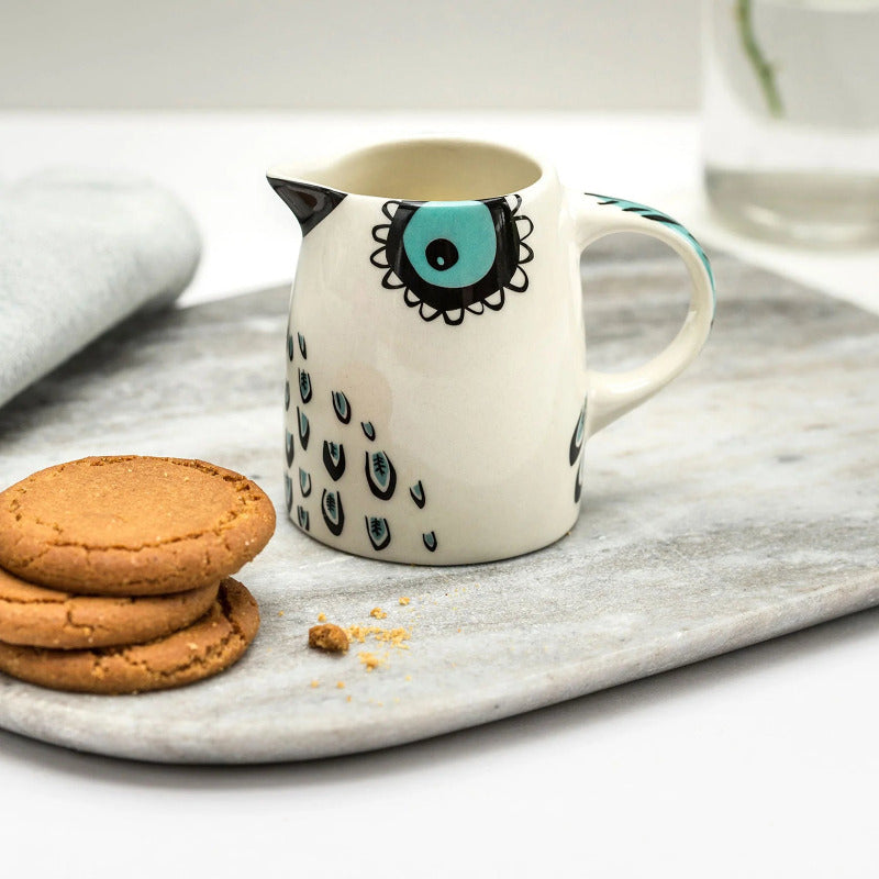 Small ceramic whiet jug with a folk art style design of an owl