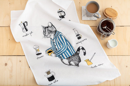 Cat in a striped jacket holding a cup of coffee