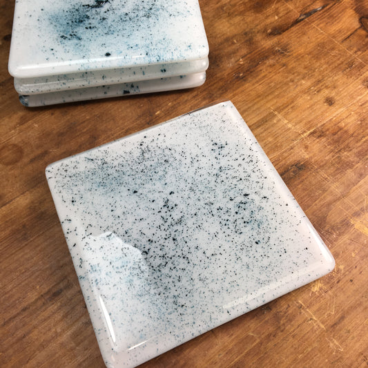 Dadswell Glass, Handmade fused glass coasters, copper oxide powder between glass creating an aqua spray of colour. Beautiful coasters to adorn your home. Made at Glass Designs a Bristol Gift shop.