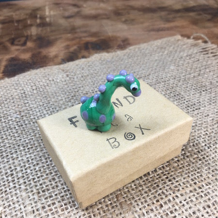 Sue Webb Friends in a box glass Dinosaur. Edit alt text