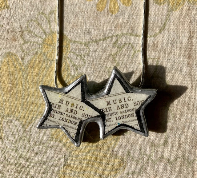 quirky 2 stars pendant, made with layered paper, metal and resin. Handmade in Cardiff by Ellymental.
