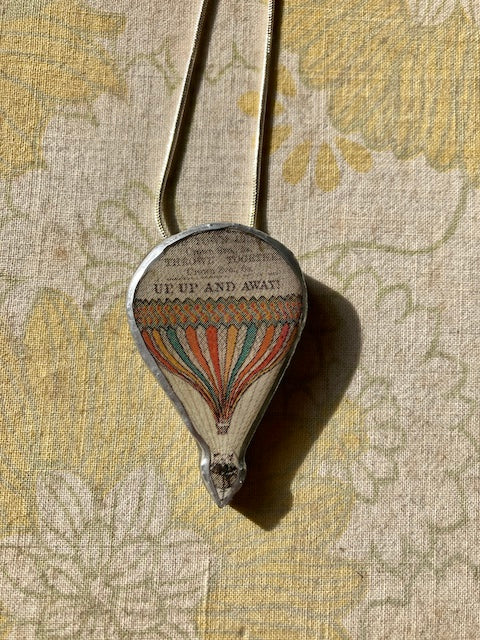 Cardiff based artist Ellymentals whimsical layered paper, metal and resin hot air balloon pendants. Small medium or large available.