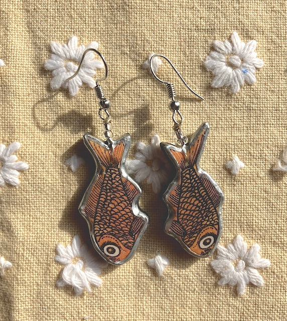 Quirky goldfish Earrings. Handmade by layering paper, metal and resin. Surgical steel ear hooks.