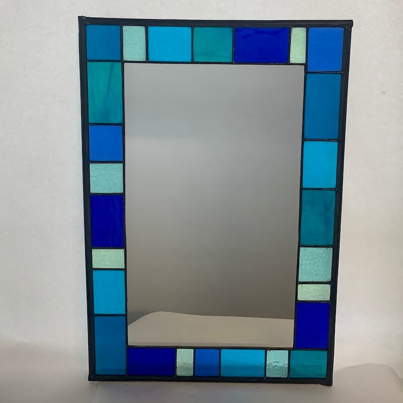 Stained Glass Mirror in Blues and Aqua colours randomly placed round edge of mirror. 40cm x 60cm with a 6 cm border.