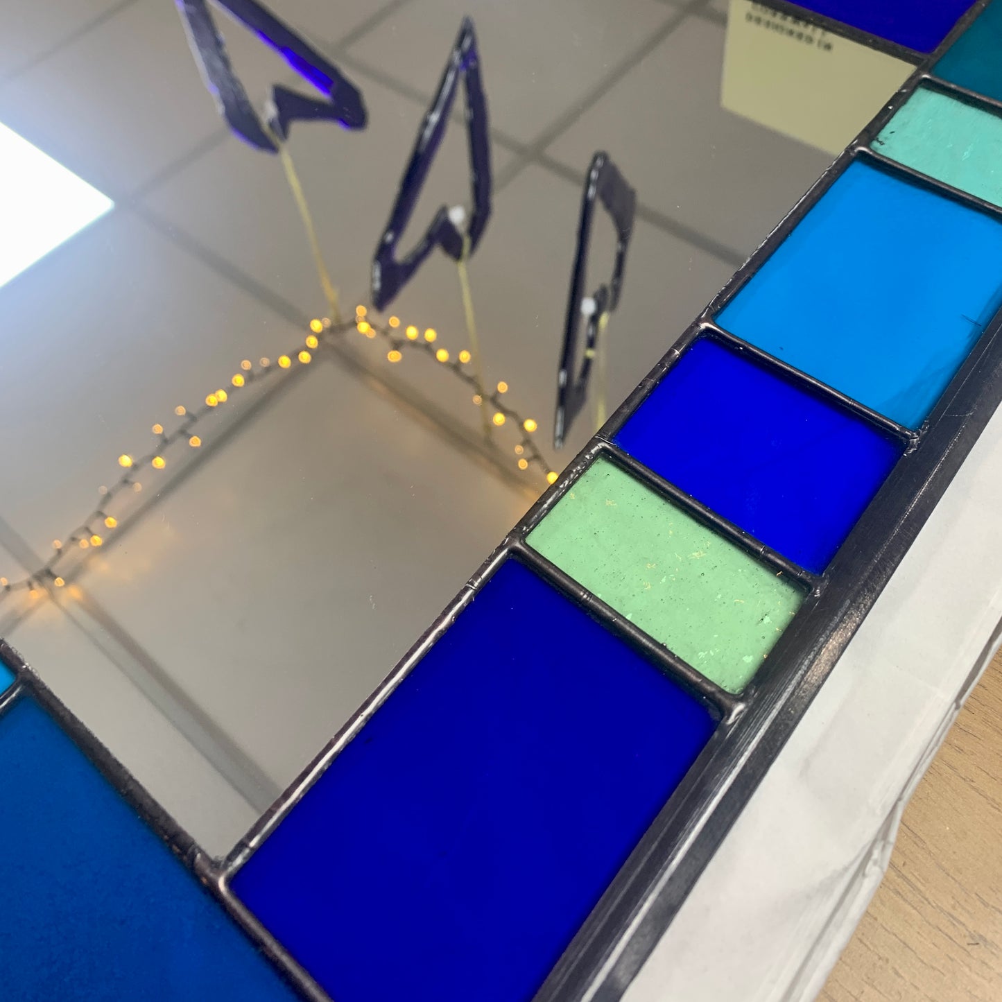 Stained Glass Mirror in Blues and Aqua colours randomly placed round edge of mirror. 40cm x 60cm with a 6 cm border.