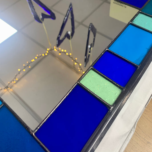 Stained Glass Mirror in Blues and Aqua colours randomly placed round edge of mirror. 40cm x 60cm with a 6 cm border.
