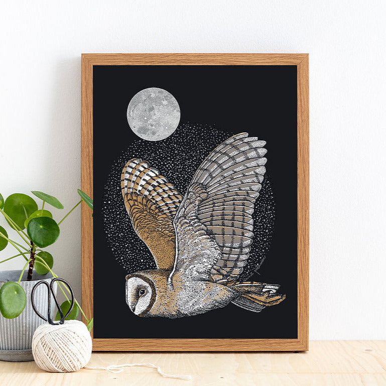 Flying owl below the moon on black background