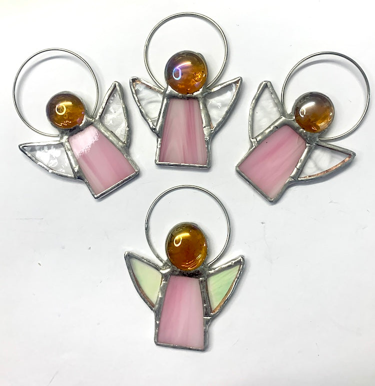 Stained Glass Angels. Individually made by hand. Many colour choices and variations. A choice of a clear or amber nugget head. The glass texture may vary slightly from the photographs. The clear glass wings will vary in texture too. Size 5cm x 7cm including halo. Glass is cut to shape and copperfoiled, followed by soldering all the pieces together. Handmade by Dadswell Glass at Glass Designs in Bristol.