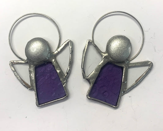 Stained Glass Angels. Individually made by hand. Many colour choices and variations. A choice of a clear or amber nugget head. The glass texture may vary slightly from the photographs. The clear glass wings will vary in texture too. Size 5cm x 7cm including halo. Glass is cut to shape and copperfoiled, followed by soldering all the pieces together. Handmade by Dadswell Glass at Glass Designs in Bristol.