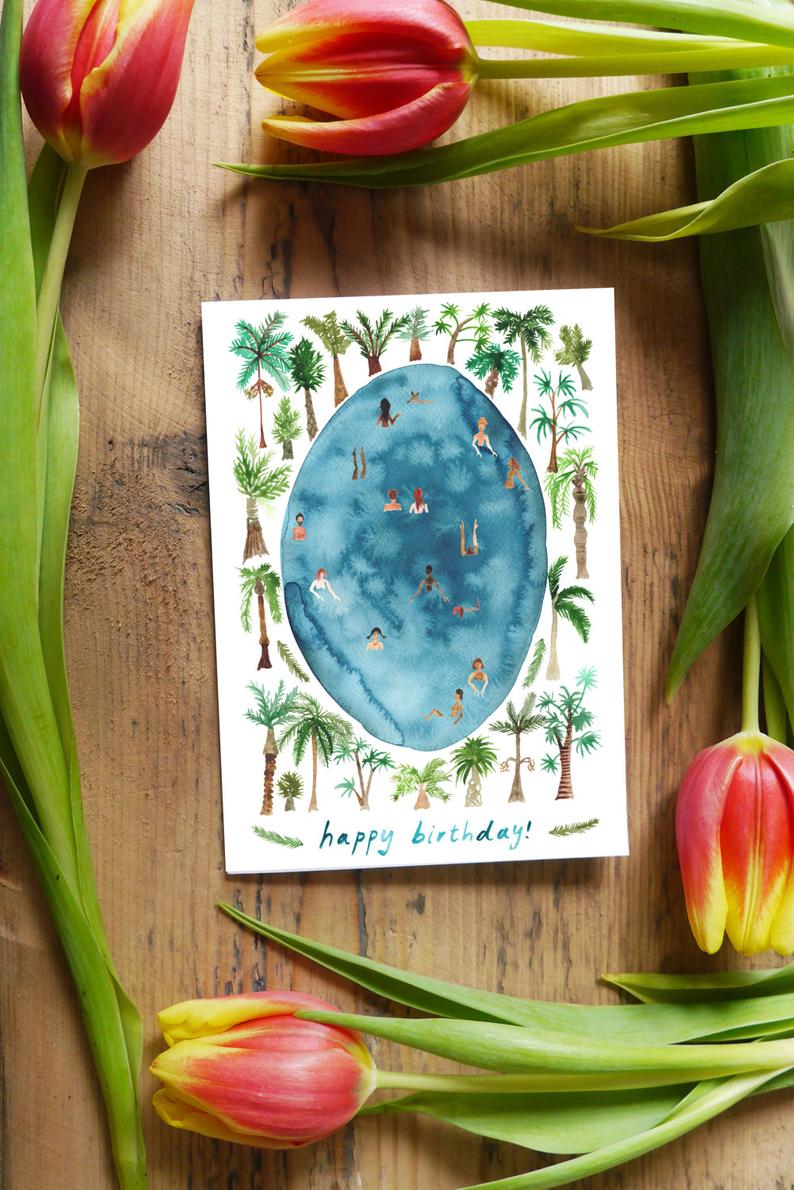 watercolour greetings card with couple and dog picnicing in a woods with lights in the trees and the words ''happy anniversary''