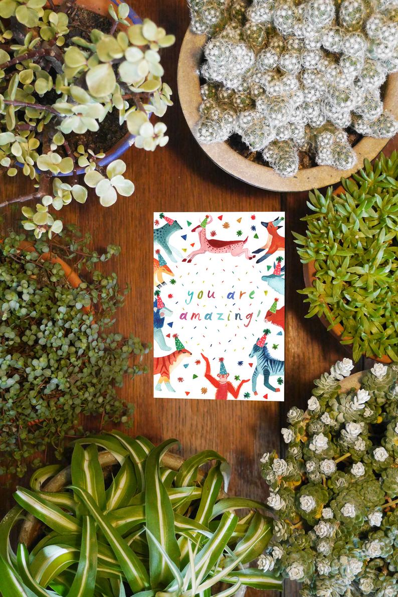 watercolour greetings card with animals in party hats and the words ''you are amazing''