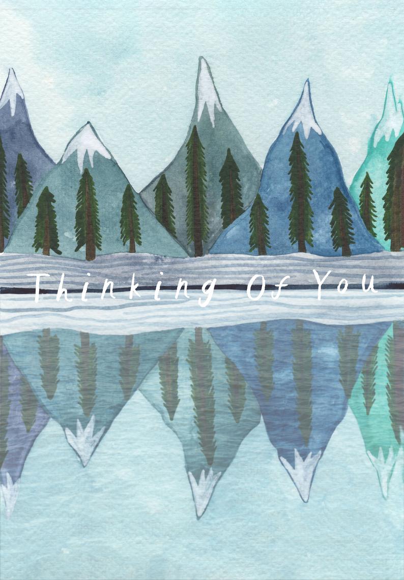 watercolour greetings card with mountains and trees reflected in a lake and the words ''thinking of you''