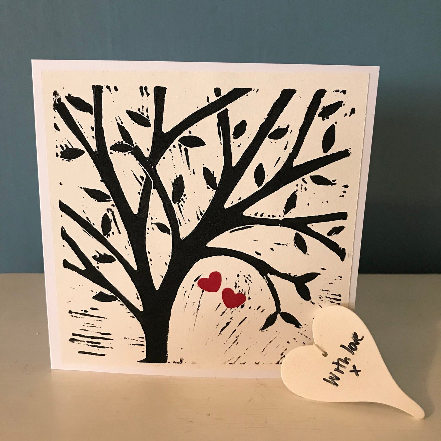 Hand printed lino cut greetings card, blank inside for your own message. Tree with 2 tiny red paper hearts attached. Perfect for a special person in your life or a lovely couple.