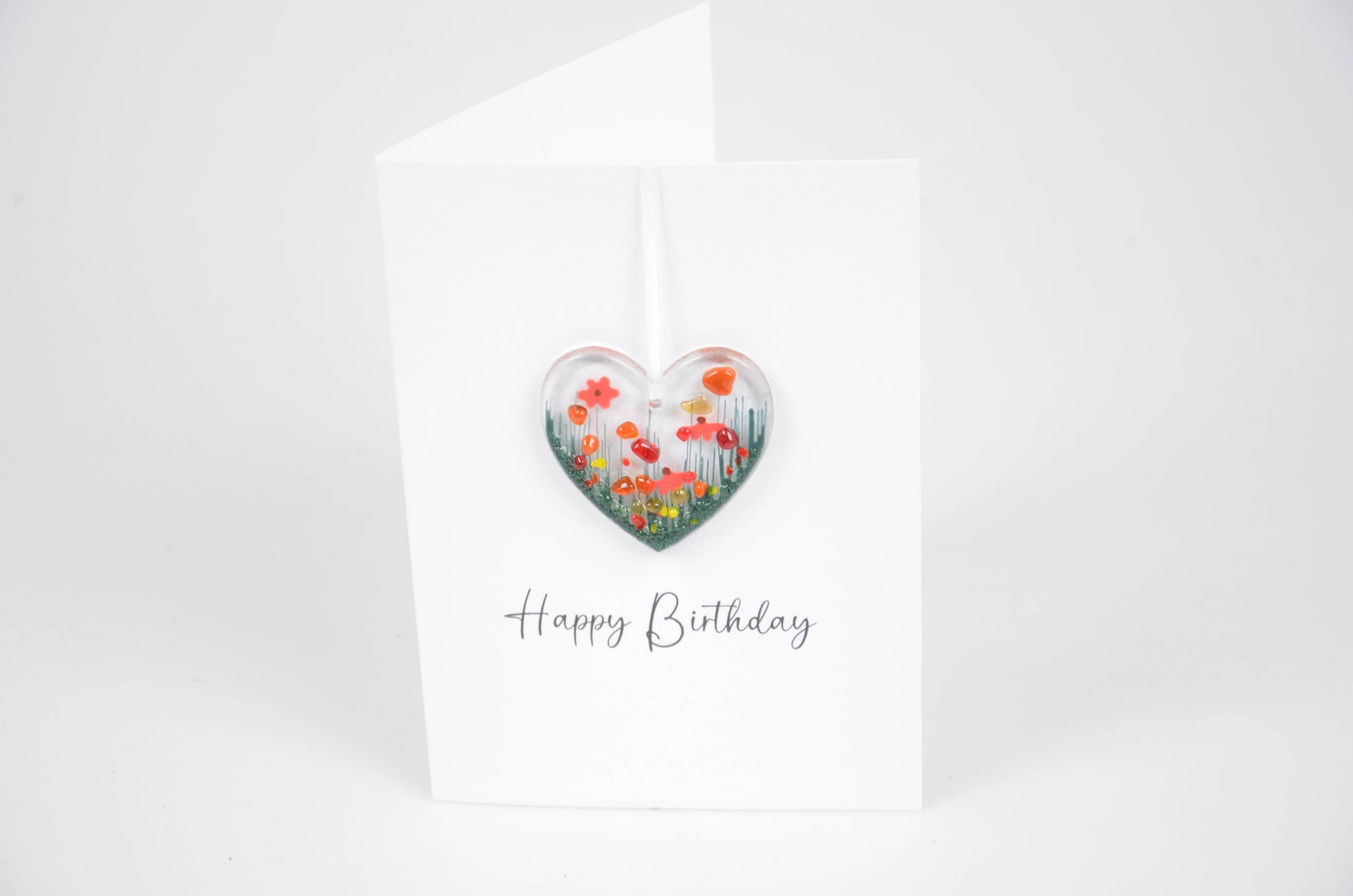 Heart-shaped floral design on a birthday card with 'Happy Birthday' text.