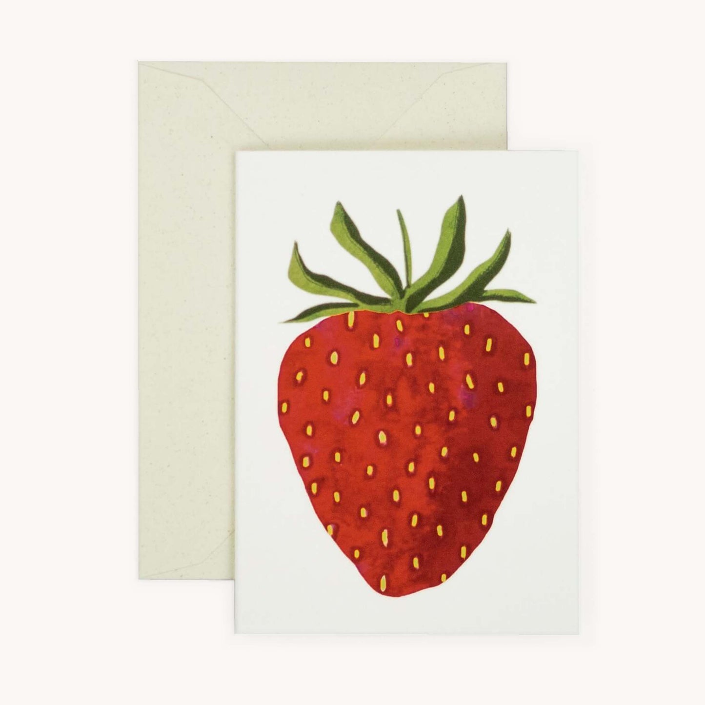 Small greetings card with envelope with a strawberry on a white background.