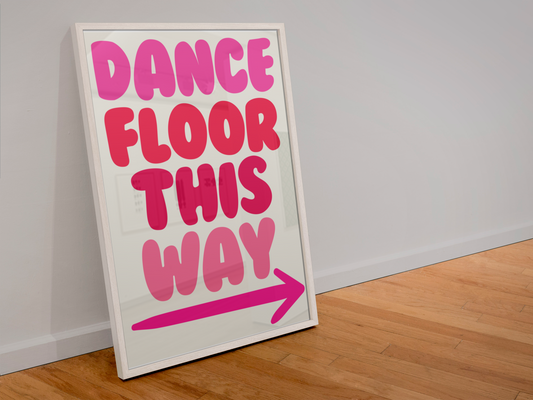 Framed sign with 'Dance Floor This Way' text on a wooden floor.