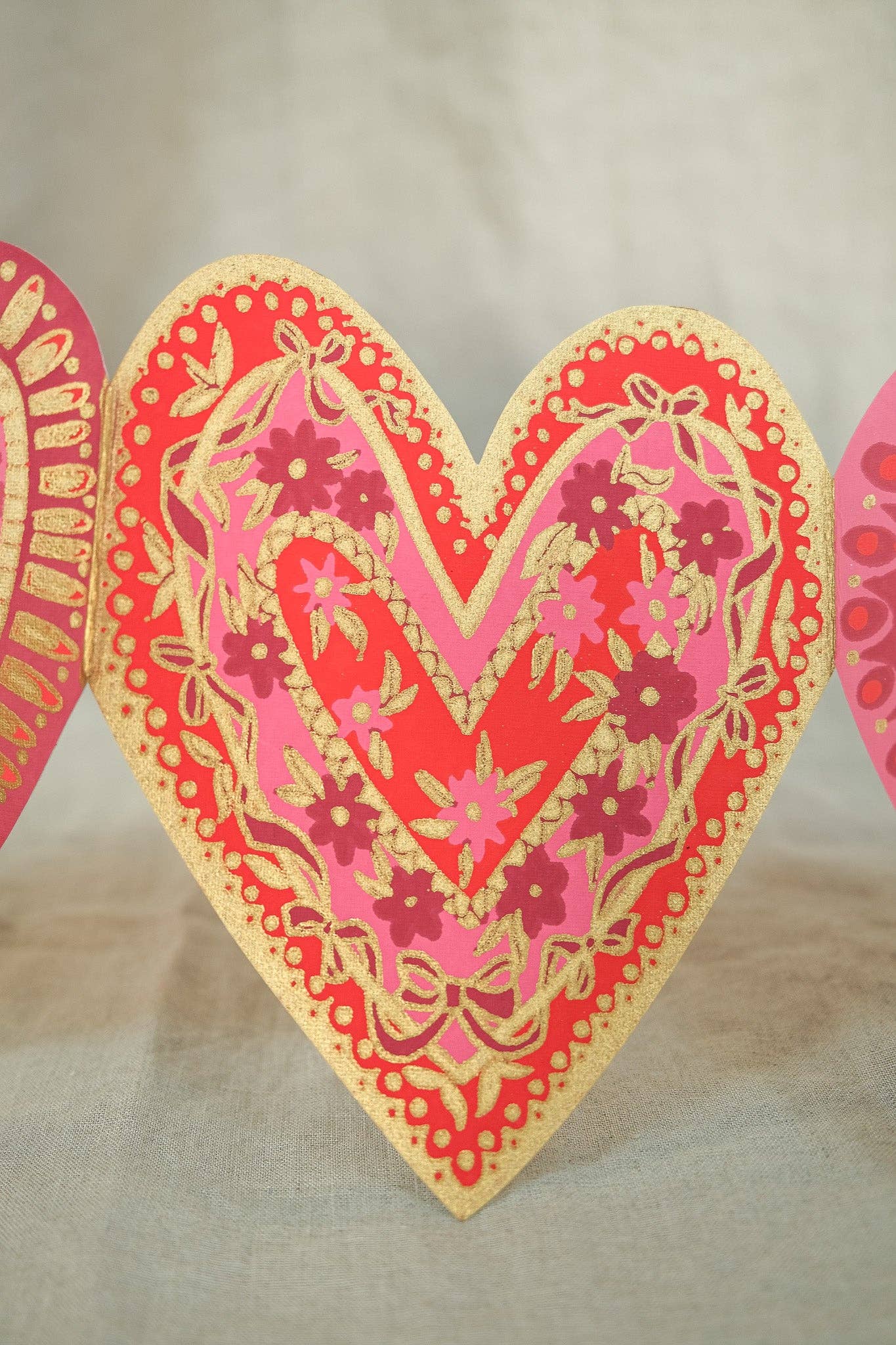 Decorative heart-shaped card with floral patterns on a beige background