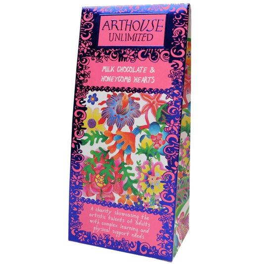 A colorful boxed product labeled 'ARTHOUSE UNLIMITED' and 'MILK CHOCOLATE & HONEYCOMB HEARTS,' shown on a plain white background. The package features a bright floral and ornamental design with purple borders and multicolored illustrations.