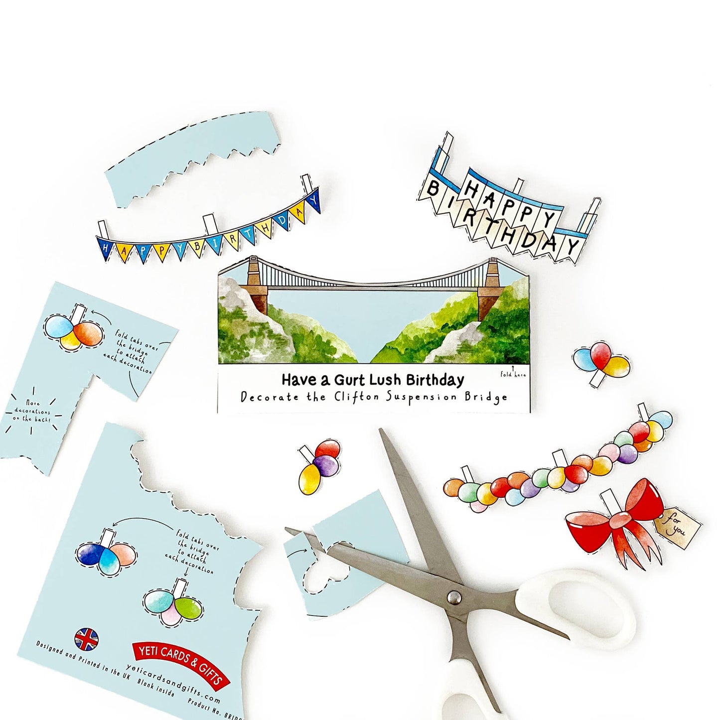 Birthday card kit with cut-out elements and scissors on a white background