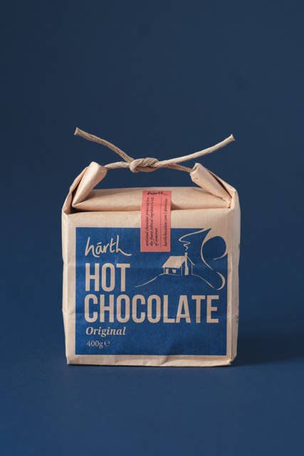 Box of hot chocolate with a blue label on a dark background