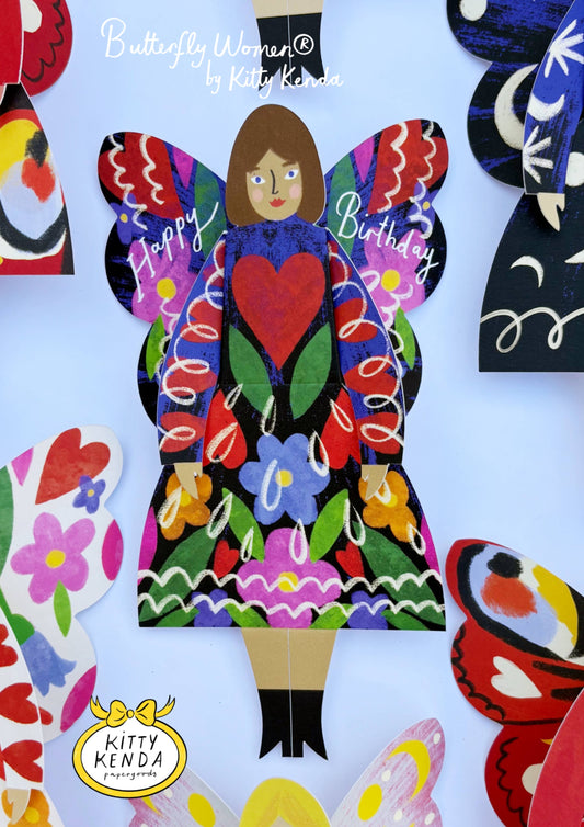 Colorful butterfly woman cutout with 'Happy Birthday' text on a white background, featuring Kitty Kenda branding.