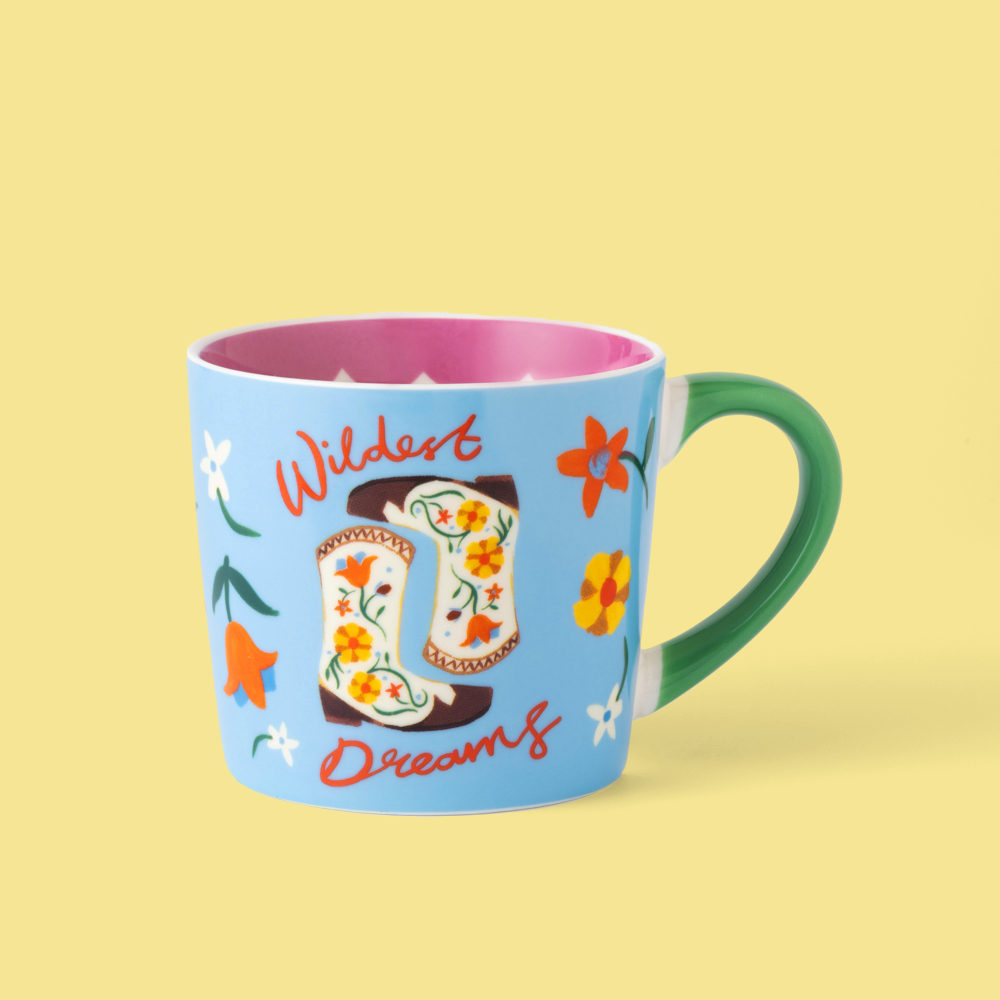 Mug with cowboy boot design and 'Wildest Dreams' text on a yellow background