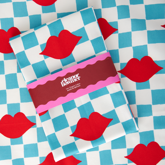 Pack of tissues with red lips on a checkered background