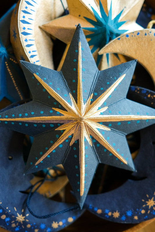 Blue and gold star-shaped decorative item with intricate patterns