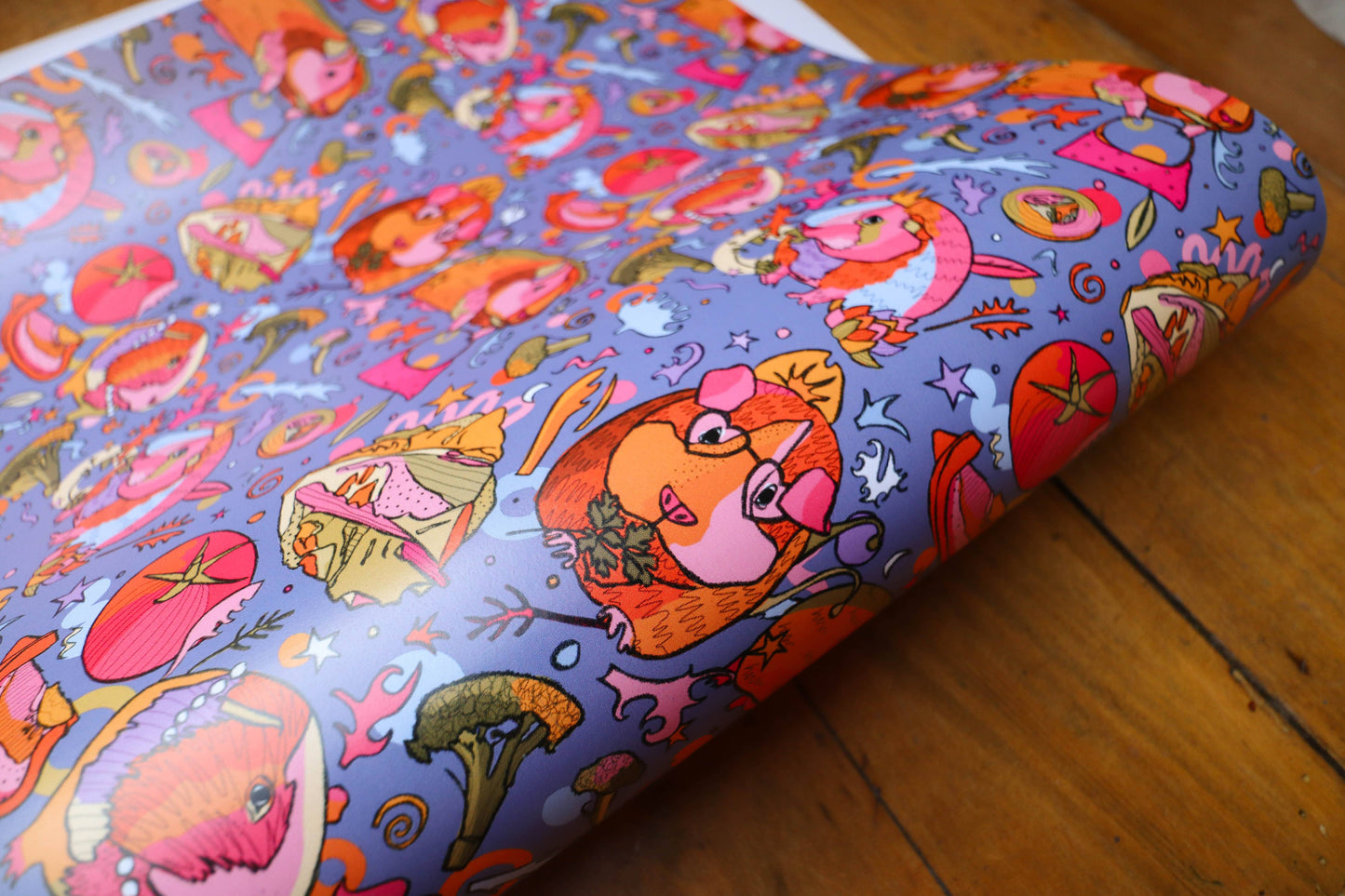 Colourful wrapping paper with guinea pigs wearing crowns.