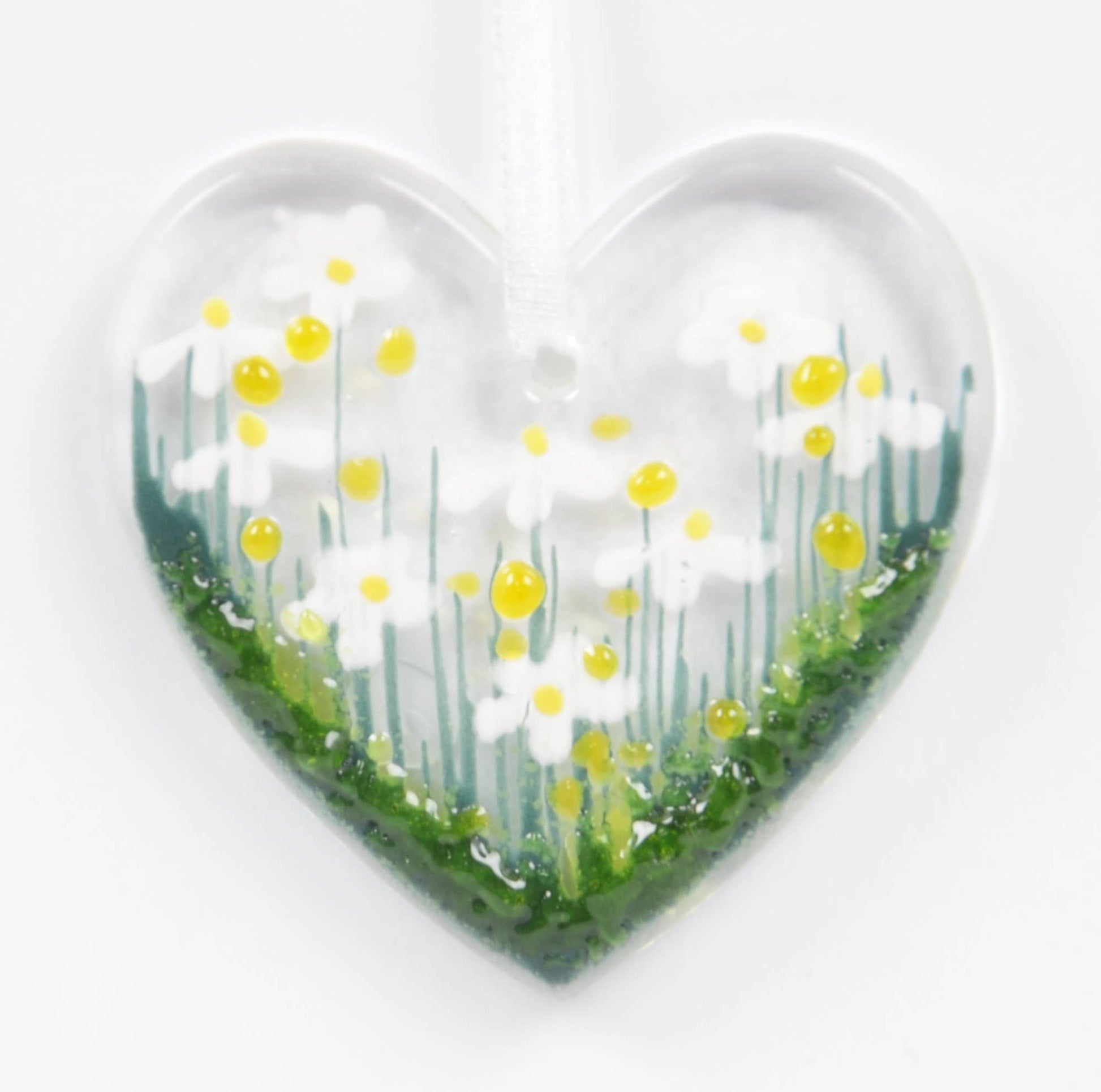 Heart-shaped object with a floral design on a white background